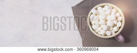 Marshmallows In Enameled Mug On Light Coloured Background
