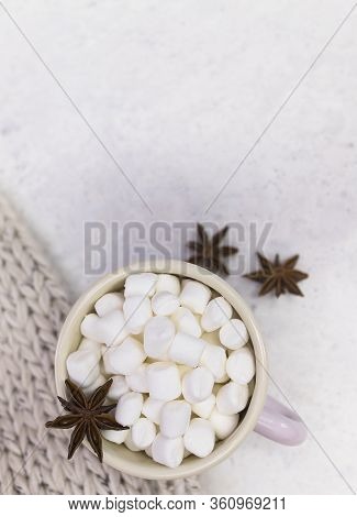 Marshmallows In Enameled Mug With Star Anise Top View