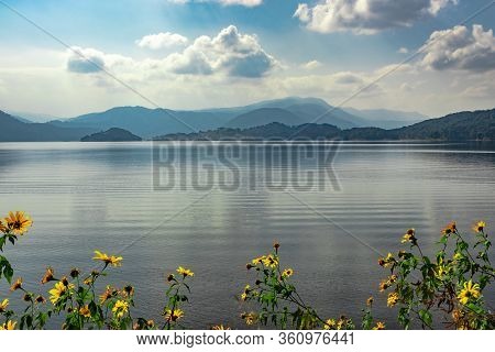 Lake Serene Blue Water With Misty Mountains And Clouds Reflections