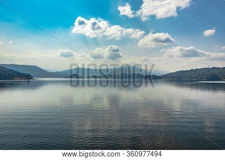 Lake Serene Blue Water With Misty Mountains And Clouds Reflections