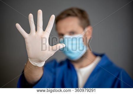 Covid-19 Outbreak. Help To Stop The Virus Spread. Male Doctor Or Nurse Wearing Face Surgical Mask An