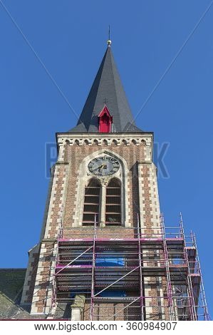 Belgium, Sint Gillis Waas, April 7, 2020 Scaffolding Stand Against The Facade Of The Church