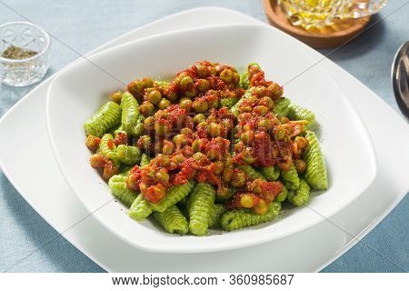 Italian Fresh Traditional Sardinian Pasta Gnocchi With Spinach And Green Pea Tomato Sauce. Spring Pa