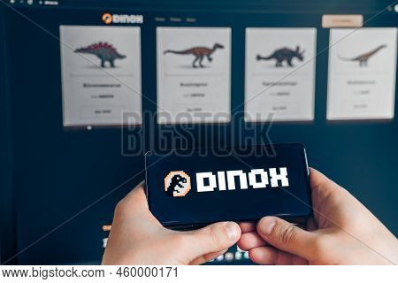 Russia Moscow 25.12.2021 Logo Of Dinox, Dnxc. Blockchain Nft Ethereum Cryptocurrency Strategy Game. 
