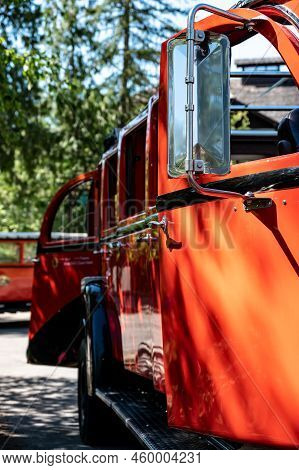 Apgar, Montana, Usa - 8.2022 - Red Bus Jammer Tour Vehicle At Glacier National Park.