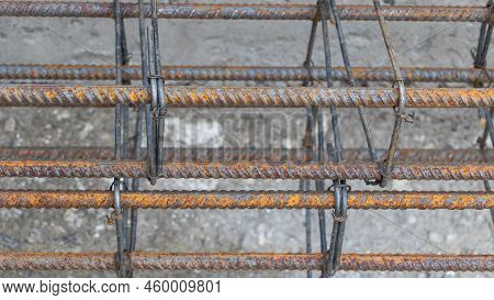 Rusty Metal Reinforcement Bars At Construction Site - From Above Of Weathered Solid Metal Armature R