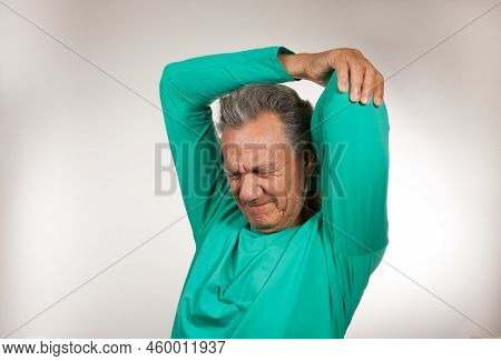 Mature Man 60plus Doing Back Of The Neck Stretches For Back And Neck Pain Relief