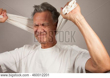 Mature Man 60plus Doing Back Of The Neck Stretches For Back And Neck Pain Relief