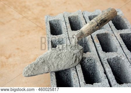 Cement Powder Or Mortar With  Trowel Put On The Concrete Brick For Construction Work.