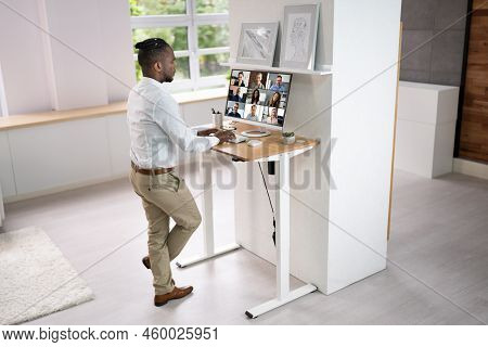 Adjustable Height Desk Stand In Office Using Computer