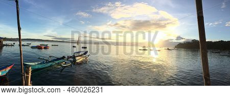 Sunrise On Pangandaran Beach, The Sun Begins To Rise, A Yellow Light Begins To Appear. The Ship On T