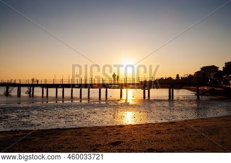 High Quality Photo Of A Pier At Sundown. Wooded Bridge Seaside With Sunset, Strunjan. Slovenia