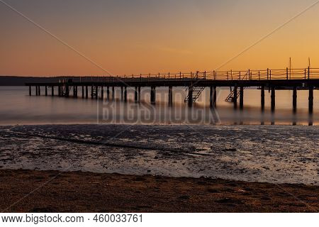 High Quality Photo Of A Pier At Sundown. Wooded Bridge Seaside With Sunset, Strunjan. Slovenia