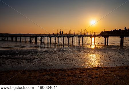 High Quality Photo Of A Pier At Sundown. Wooded Bridge Seaside With Sunset, Strunjan. Slovenia