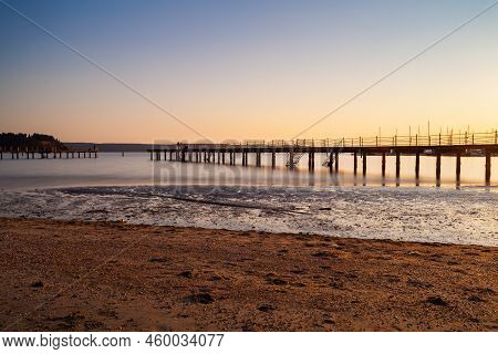 High Quality Photo Of A Pier At Sundown. Wooded Bridge Seaside With Sunset, Strunjan. Slovenia