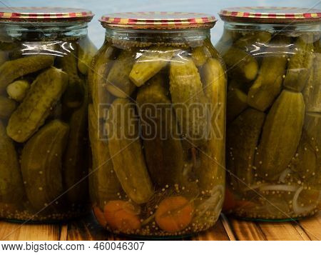 Preservations, Conservation. Salted, Pickled Cucumbers In A Jars On An Wooden Table. Pickling Cucumb