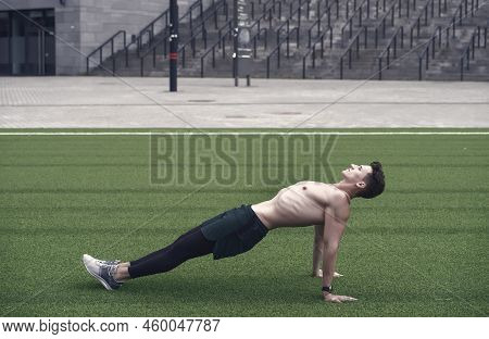Sporty Man Making Back Plank Exercise. Guy In Reverse Plank Exercise. Yoga Fitness Man Stretching Bo