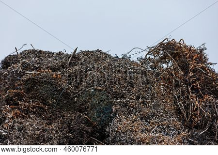 Pile Of Metal Swarf On Blue Sky Background, Close-up.