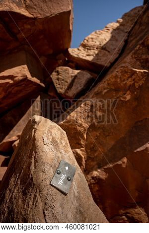 Small Trail Directional Sign Through Rocks Points To A Steep Climb In Canyonlands National Park