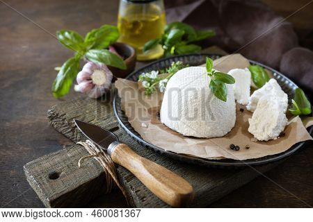 Homemade Italian Ricotta Cheese Or Cottage Cheese With Basil On A Rustic Table. Vegetarian Healthy D