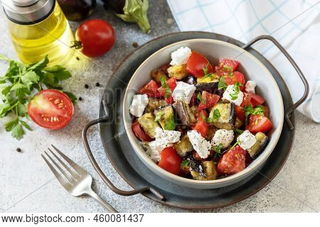 Healthy Vegetarian Diet Food. Salad With Grill Eggplants, Tomatoes And Feta Cheese On A Gray Stone T