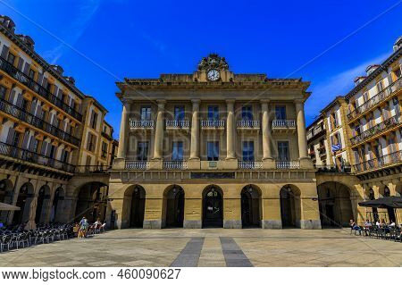 San Sebastian, Spain - June 26, 2021: Ornate Arched Houses With Metal Balconies And Flowers On Const