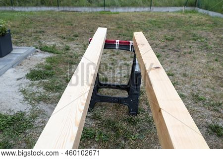 Raw Planed Pine Wooden Beams, Dimensions 100x100mm, Lying Next To Each Other.