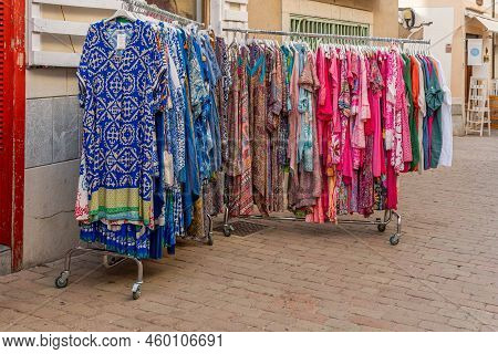 Arta, Spain; August 13 2022: Street Stall Selling Colorful Dresses In Shades Of Blue And Pink. Arta,