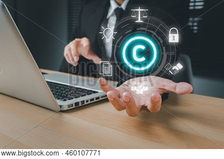 Copyright Or Patent Concept, Business Person Hand Holding Vr Screen Copyright Icon With Blue Bokeh B