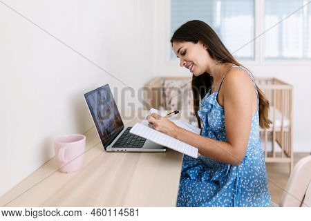 Cheerful Young Adult Student Woman Having A Video Call On Laptop Computer. Millennial Female Taking 