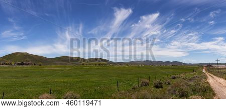 Cloudscape Over The Green Fields In A City During Sunny Day. Evanston, Wyoming, United States Of Ame
