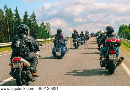 Group Of Motorcyclists Rides On Asphalt Country Road On Summer Sunny Day. Parade Of Motorcycles - Li