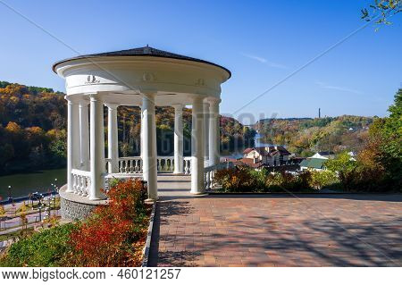 White Gazebo In City Park Of Zhytomyr, Ukraine At Sunny Autumn Day. Picturesque View On Colourful Hi