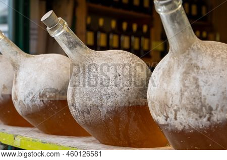 Big Bottles With White Wine Austrian Vinegar Made From Local Grapes On Market In Vienna, Austria