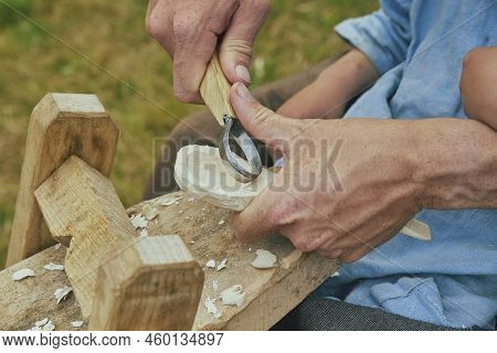 Retro Photo. Carpenter Carving A Spoon Close-up