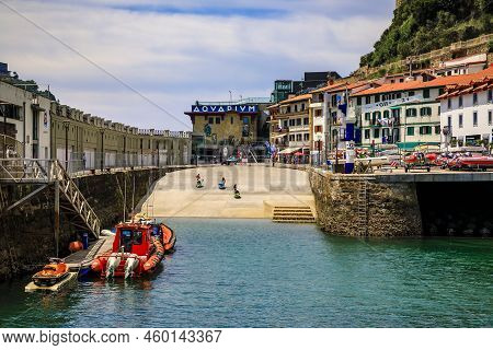 San Sebastian, Spain - June 26 2021: View Of Turquoise Water By The Aquarium And Red Medical Boats O