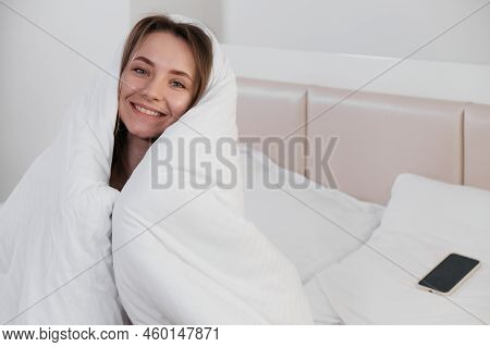Pretty Young Smiling Caucasian Woman Waking Up In The Morning And Stretching In Her Bed And Looking 