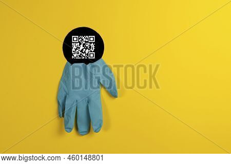 Disposable Medical Gloves Blue Color Through Black Hole In A Yellow Background. Stay Safe. Concept O