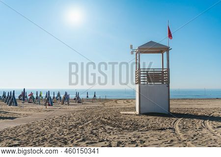 Beach At The Adriatic Sea Coastline In Italy, Europe During Summer. Traditional Hut For The Beach Li