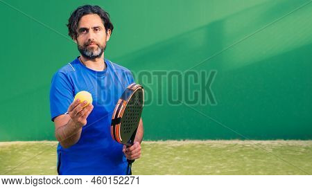 Monitor Of Padel Holding Black Racket With Yellow Tennis Ball In The Hand.