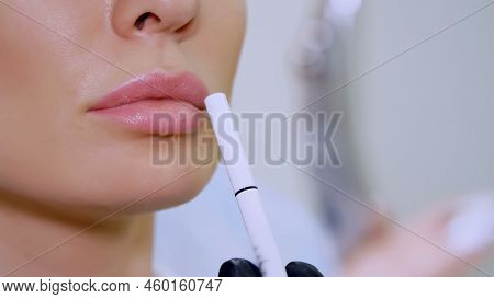 Clinic, A Beauty Salon, A Large Plan Of The Lips, The Doctor Shows The Patient A Lip Zone For Inject