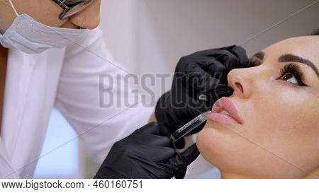 Medical Office, Doctor In Black Sterile Gloves, Injecting Hyaluronic Acid Into The Patient Lips. Pro