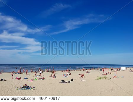 Latvia, Jurmala, August, 2022 - People Enjoying Relaxing On The Baltic Sea Beach In Jurmala, Latvia.