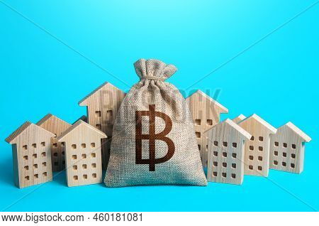 Thai Baht Money Bag Among Town Houses Figurines. Municipal Budgeting. Rich City. Rental Business. Sa
