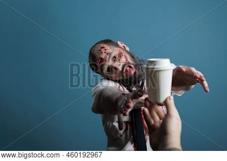 Aggressive Halloween Corpse Wishing To Drink Coffee Cup In Studio, Going After Beverage And Wanting 