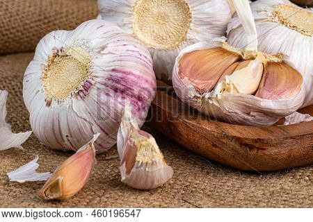 Slices And Whole Bulb Of Garlic Close Up. Selective Forus.