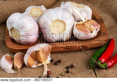 Cloves And Whole Bulb Of Garlic With Scattered Cloves Close Up. Selective Forus.
