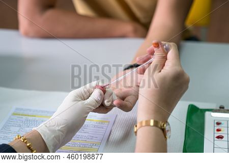 Nurse Drawing Blood From Patient's Finger. Close Up Shot.