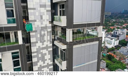 Workers Are Using Gondola As Vertical Trasport To Install Aluminum Composite On The Construction Bui