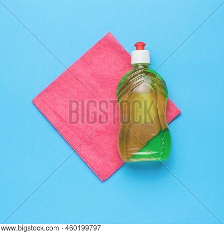 A Red Cleaning Cloth And Cleaning Agent On A Blue Background. Cleaning Kit. Flat Lay.